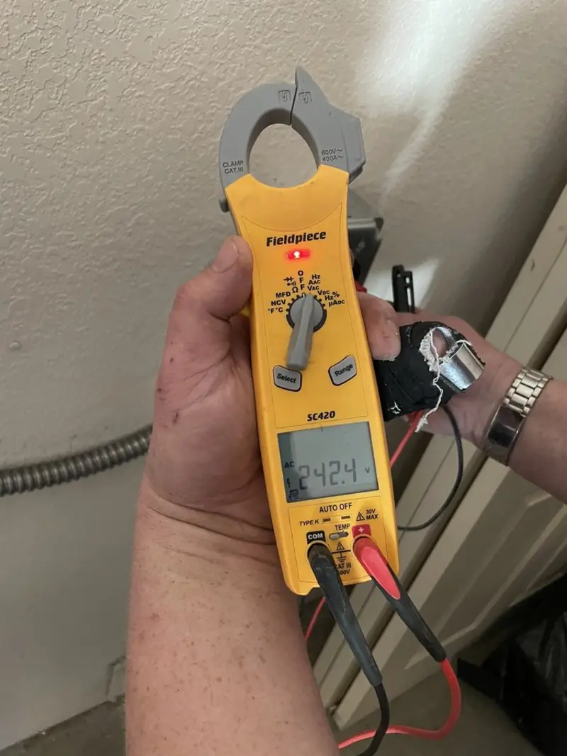 Voltage testing with clamp meter during Outlet Installation in University of Virginia